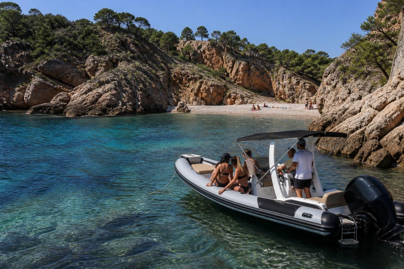 Small motorboat entering a rocky turquoise cove on the Costa Brava