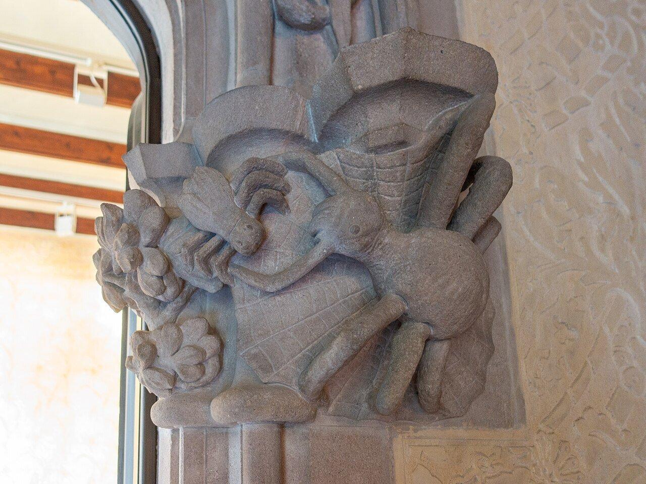 A carved stone dragon curling around a column at Casa Amatller