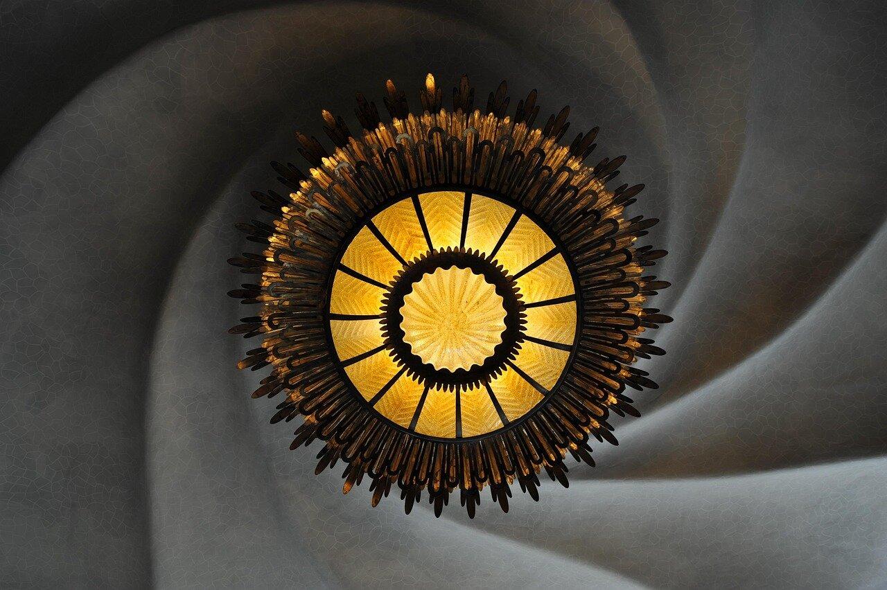 A glowing circular light beneath the curved ceiling at Casa Batlló