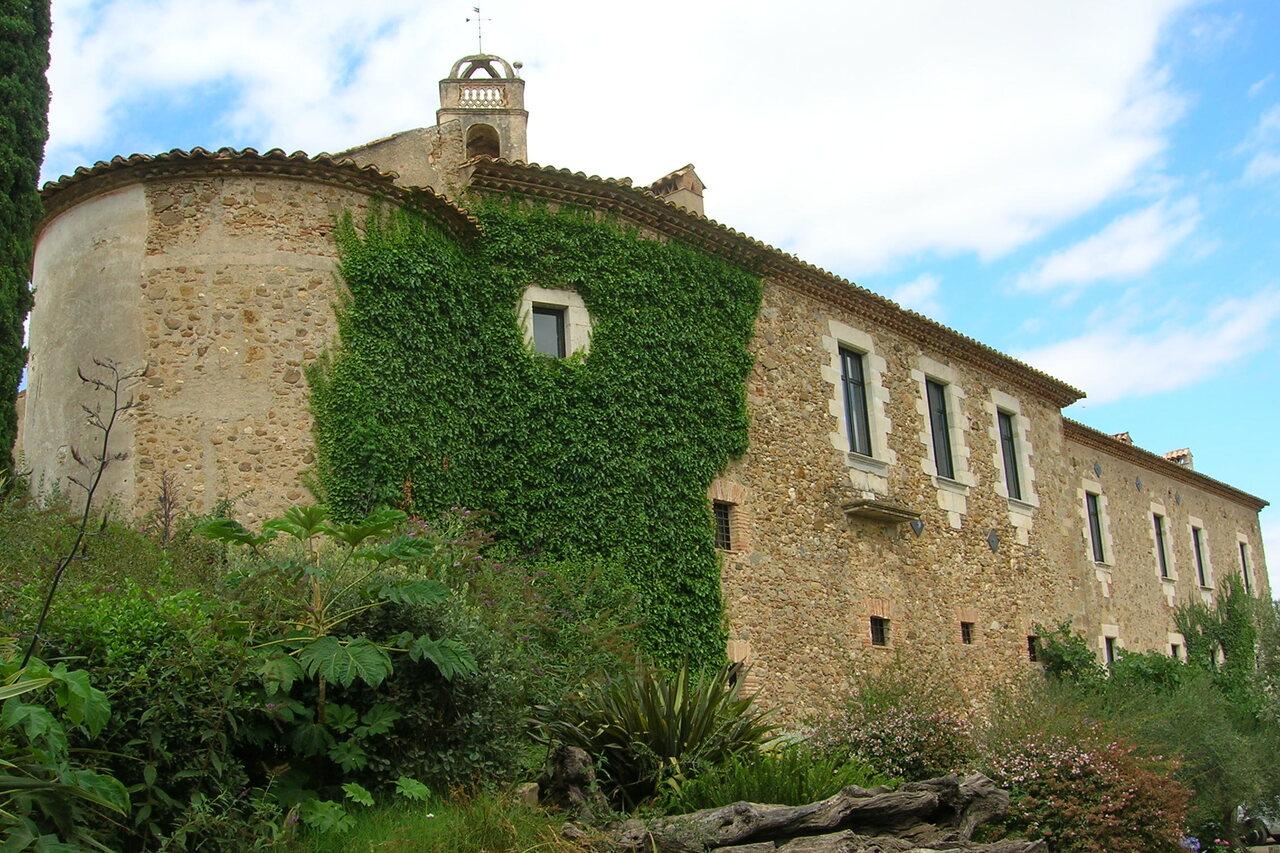 Stone walls, garden and tower of Castell d’Empordà